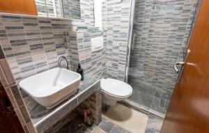 a bathroom with a sink and a toilet at Awesome Home In Karlovac in Karlovac