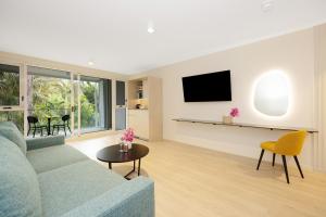 a living room with a couch and a table at Picnic Bay Hotel in Picnic Bay