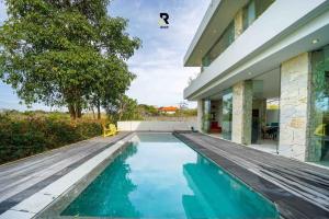 a swimming pool in the backyard of a house at NEW, Modern 1BR with Pool-Kitchen-Workspace-100Mb in Badung