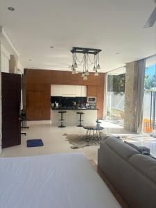 a living room with a couch and a kitchen at NEW, Modern 1BR with Pool-Kitchen-Workspace-100Mb in Badung