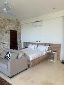 a bedroom with a large bed and a couch at NEW, Modern 1BR with Pool-Kitchen-Workspace-100Mb in Badung +26 photos