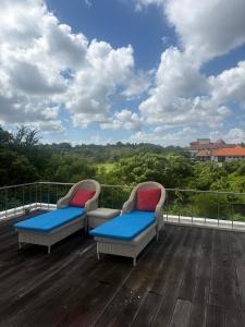 two chairs sitting on top of a deck with a view at NEW, Modern 1BR with Pool-Kitchen-Workspace-100Mb in Badung