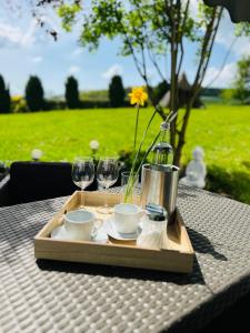 a tray with wine glasses and cups on a table at Refugium 2020 in Marienheide