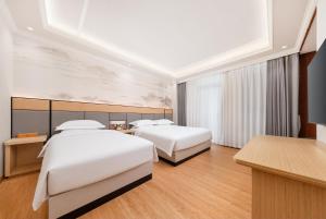a hotel room with two beds and a desk at Tangshan Yipin Hot Spring Hotel in Nanjing +9 photos