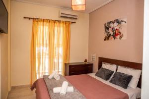 a bedroom with two beds and a window at Stylida Apartment - Ocean Air & Quiet Nights! in Stilís