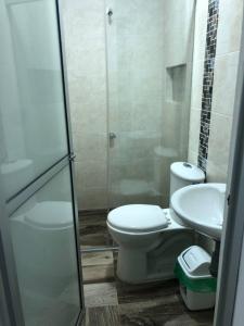 a bathroom with a toilet and a sink at Casa Hotel Ortiz in Apartadó