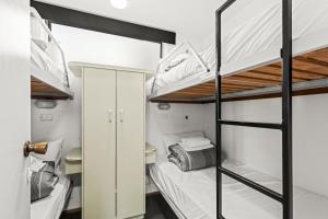 a room with two bunk beds and a desk at Ingenia Holidays Torquay Australia in Torquay +33 photos
