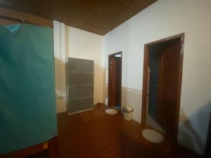 a bathroom with a shower and a toilet in a room at Be My Guest Hostel in Panglao Island