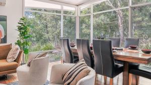 a dining room with a table and chairs at Aria House in Trentham +18 photos