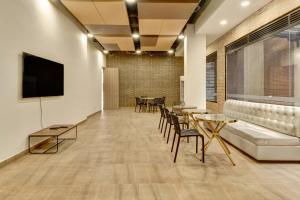 a conference room with a couch and tables and chairs at Hotel EspacioYa By Mario Rental 103 in Bogotá