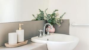a bathroom with a sink and a plant at Aria House in Trentham