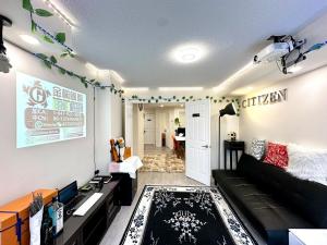 a living room with a black couch and a table at Comfortable 2BR Getaway with Extra Lounge Space in Toronto