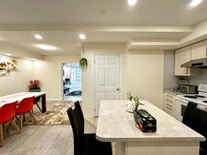 a kitchen and dining room with a table and chairs at Comfortable 2BR Getaway with Extra Lounge Space in Toronto