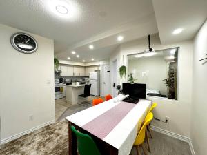 a room with a table and chairs and a kitchen at Comfortable 2BR Getaway with Extra Lounge Space in Toronto +14 photos
