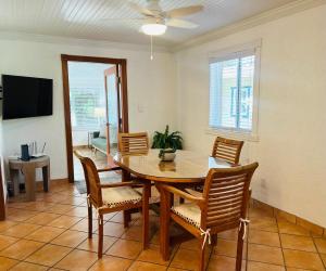 a dining room with a table and chairs at Serenity Sands Cayman in Bodden Town