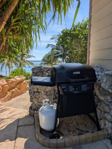 a barbecue grill sitting outside of a house at Serenity Sands Cayman in Bodden Town