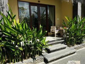 a group of plants in front of a house at Pulu Sari Suite Ubud in Ubud