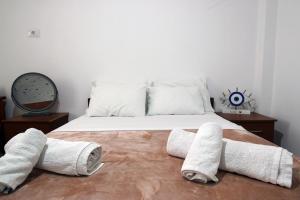 a bedroom with a bed with towels on it at Lakeview Villa Nardi in Ksamil +30 photos