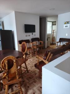 a living room with wooden chairs and a table at apartamento vacacional red in Salento