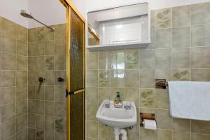 a bathroom with a sink and a shower at Coastline Callala - Fire Pit - Pet Friendly in Callala Beach +17 photos