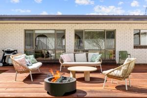 a patio with chairs and a fire pit at Coastline Callala - Fire Pit - Pet Friendly in Callala Beach