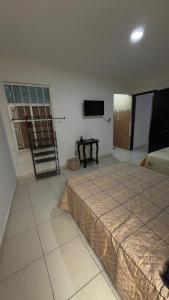 a bedroom with a bed and a television in it at Hogar ideal in Orizaba