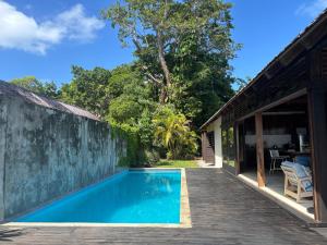 a house with a swimming pool and a wooden deck at Kooyu Villas in Port Vila