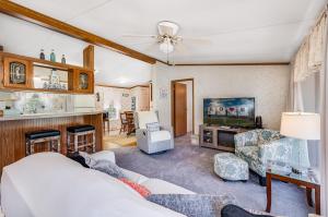 a living room with a couch and a tv at One Peace Cottage in Deep Hole