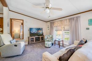 a living room with a couch and a tv at One Peace Cottage in Deep Hole
