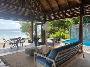 an outdoor living room with a view of the ocean at Kooyu Villas in Port Vila