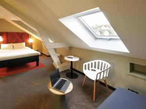 a attic room with a bed and a skylight at ibis Maisons Laffitte in Maisons-Laffitte +91 photos