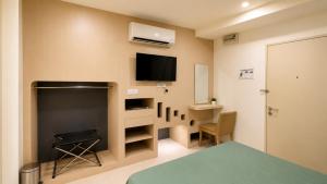 a room with a fireplace and a tv on the wall at JSD Hotel in Petaling Jaya