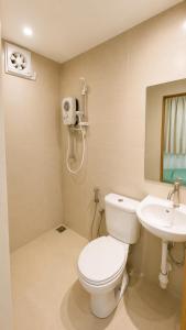 a bathroom with a toilet and a sink at JSD Hotel in Petaling Jaya +14 photos