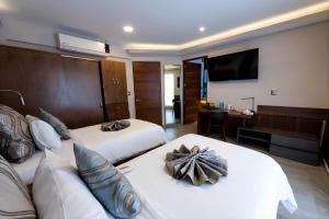 a hotel room with two beds and a couch at JTowers in Mexico City +58 photos