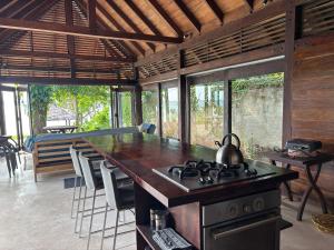a kitchen with a stove with a tea kettle on it at Kooyu Villas in Port Vila