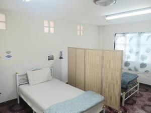 a small hospital room with a bed and a window at The Jetty in Nathon Bay