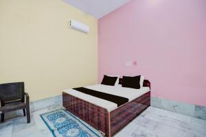 a bedroom with a bed and a chair at Hotel Shivam palace in Lalitpur