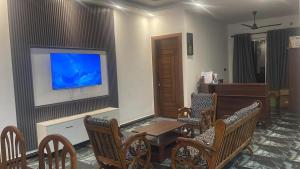 a living room with a table and chairs and a tv at JK Residence Trincomalee in Trincomalee