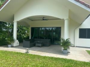 a patio with a couch and a table at Private Pool Villa Huay Yai in Ban Bung