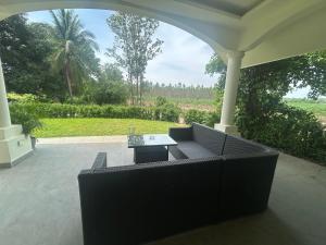 a living room with a couch and a table at Private Pool Villa Huay Yai in Ban Bung +2 photos