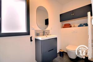 a bathroom with a sink and a mirror and a toilet at Entre terre et mer in Cherrueix +13 photos