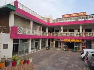 a hotel with a parking lot in front of it at Hotel Vrindavan in Fatehpur Sīkri