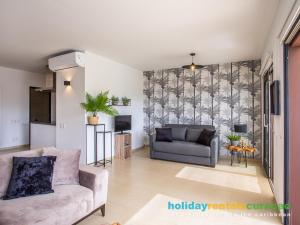 a living room with a couch and a table at Apartment 387 Blue Bay in Dorp Sint Michiel