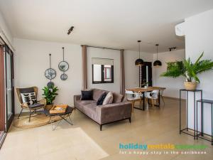 a living room with a couch and a table at Apartment 387 Blue Bay in Dorp Sint Michiel