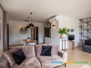 a living room with a couch and a table at Apartment 387 Blue Bay in Dorp Sint Michiel