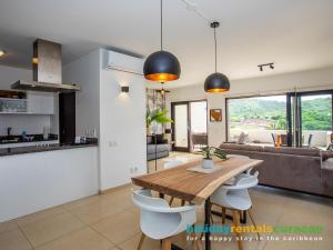 a kitchen and living room with a wooden table and chairs at Apartment 387 Blue Bay in Dorp Sint Michiel