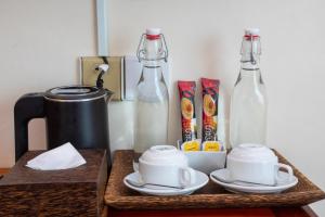 a table with a coffee maker and two glass bottles at Apsor Villa in Phumĭ Réach Born (2)