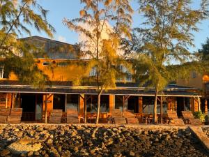 a building with trees in front of it at Bon Vivant Front de Mer - Ile Rodrigues in Rodrigues Island