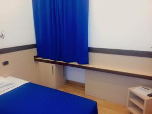 a blue curtain in a room with a bed at Hotel Louisiana in Rome