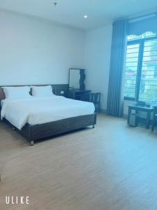 a bedroom with a large bed in a room with blue lighting at Khách Sạn VizGoo in Bắc Ninh